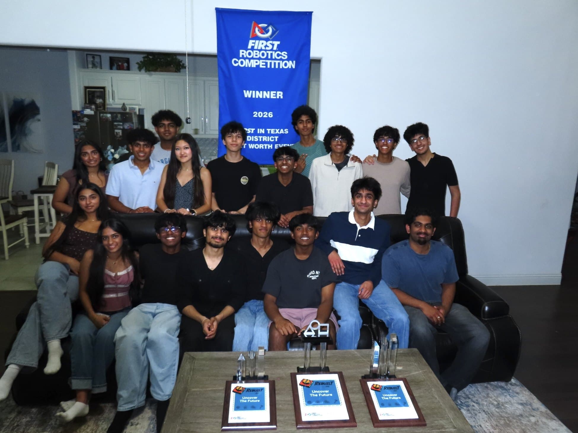 Members of Singularity Robotics at their team headquarters with the FIRST in Texas District Fort Worth Event winner's banner and three event awards. Photo: Singularity Robotics, FRC Team 10032
